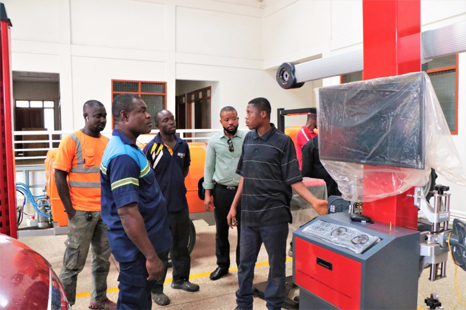 An Assistant at COLTEK's Automotive Workshop (extreme right) introducing a machine to the guests
