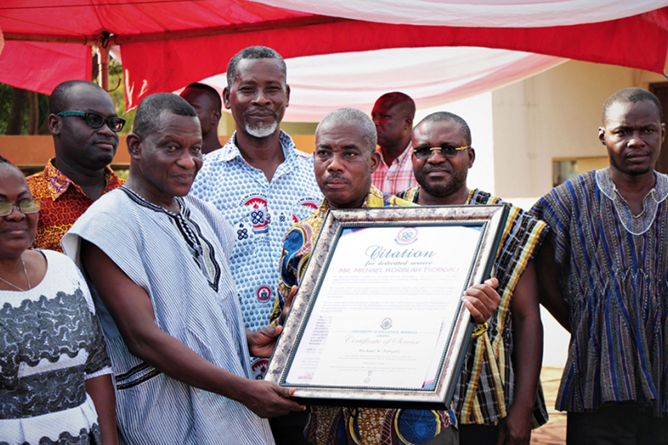 Prof. Frederick K. Sarfo (fourth from right) handing over a citation to Mr. Michael K. Tsorgali while other family members and staff look on