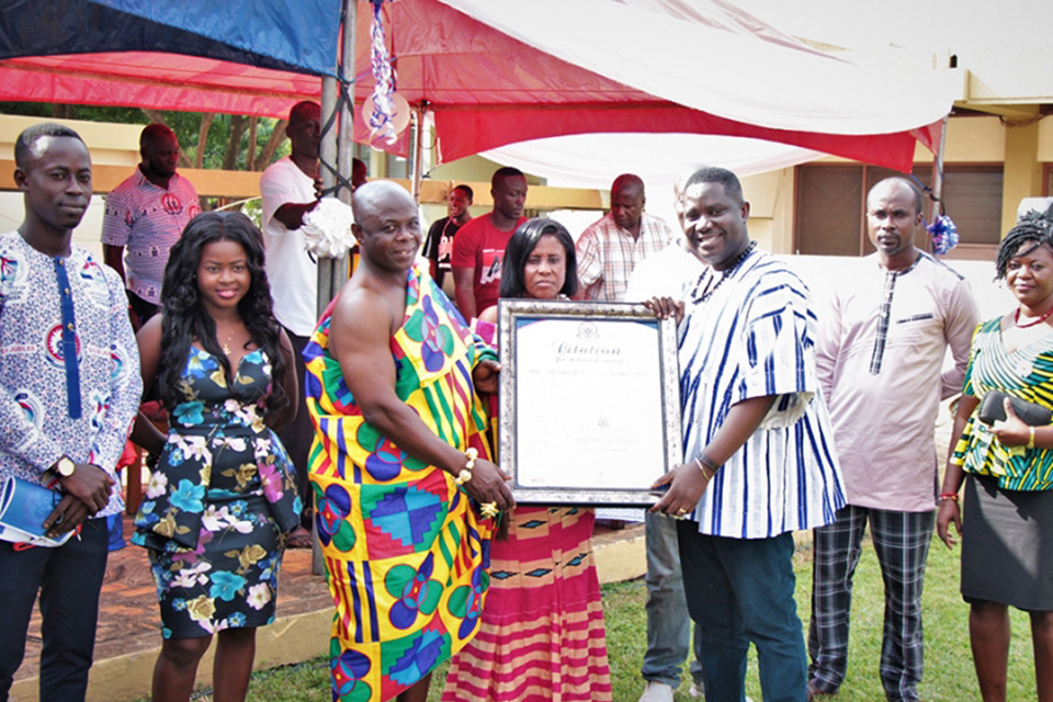 Mr. George Kwadwo Frimpong (wearing kente cloth) receiving citation from Dr. Gilbert Owiah-Sampson, Dean of the Faculty of Vocational Education (FVE)
