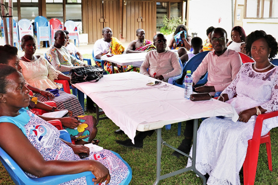 Two of the retirees - Ms. Hannah Danquah (first from right) and Mr. Peter Akotia (wearing golden kente cloth over white jumper) - with their families and friends listening to the address by Prof. Frederick K. Sarfo. 