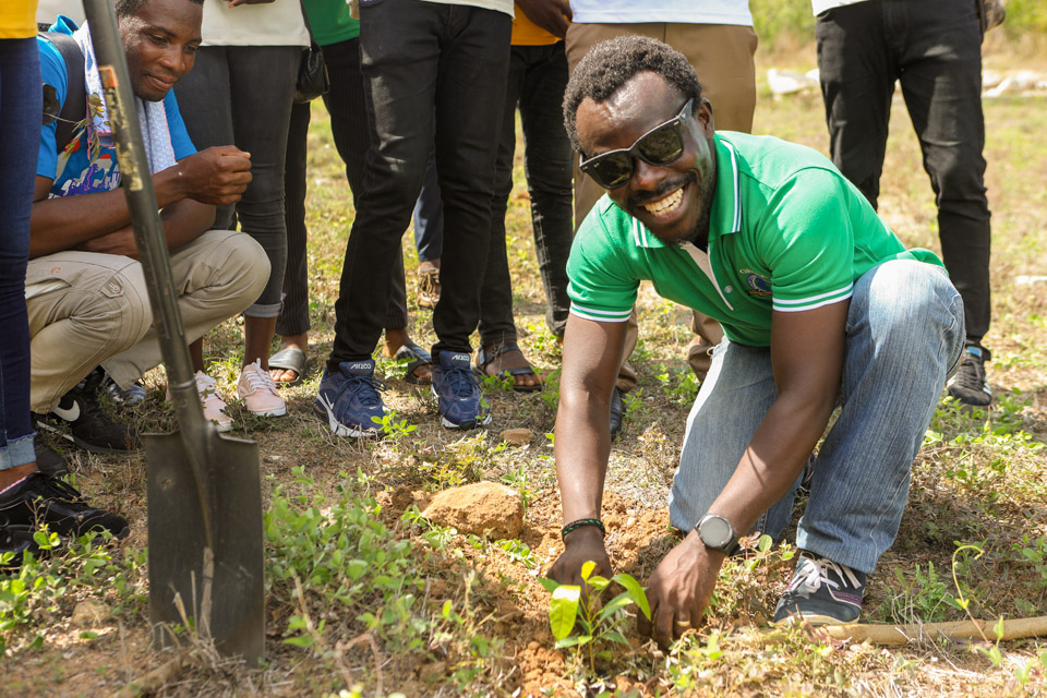 Dr. Yaw Asamoah planting a seedling during the tree planting exercise