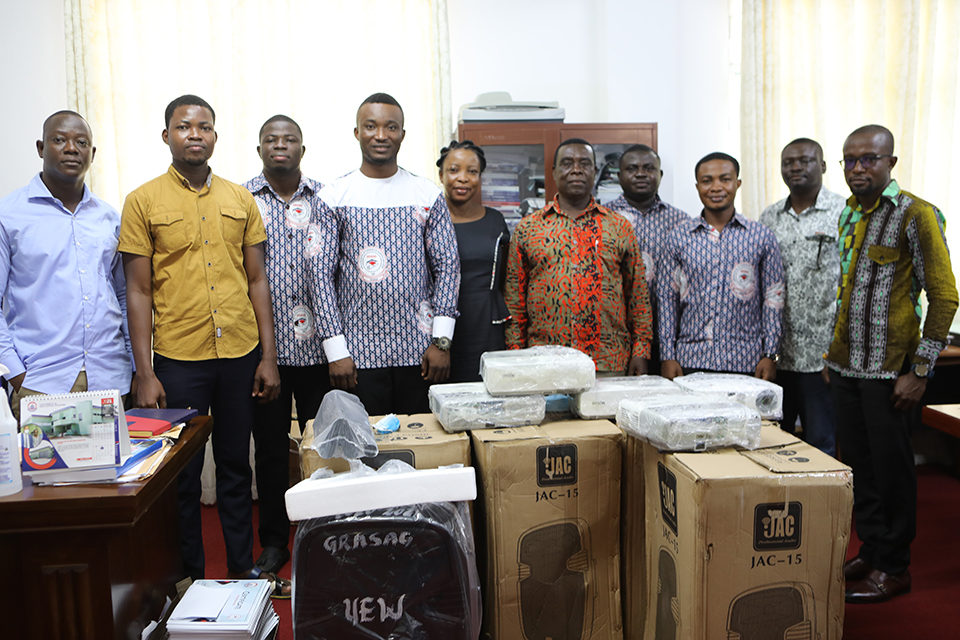 Mr. Enoch Ansah (fourth from left) and colleague executives in a group pose with staff from SGS after a short presentation