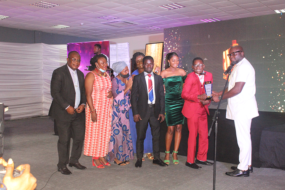 One of the special needs student and his colleagues receiving an award for the campus radio programme, "Disability Focus" 