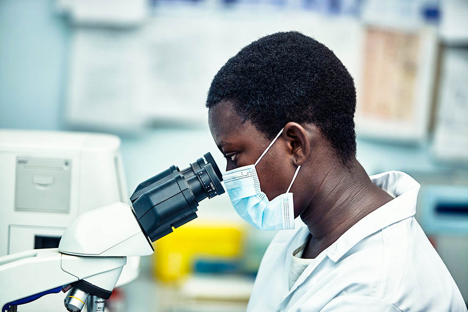 A girl behind a microscope