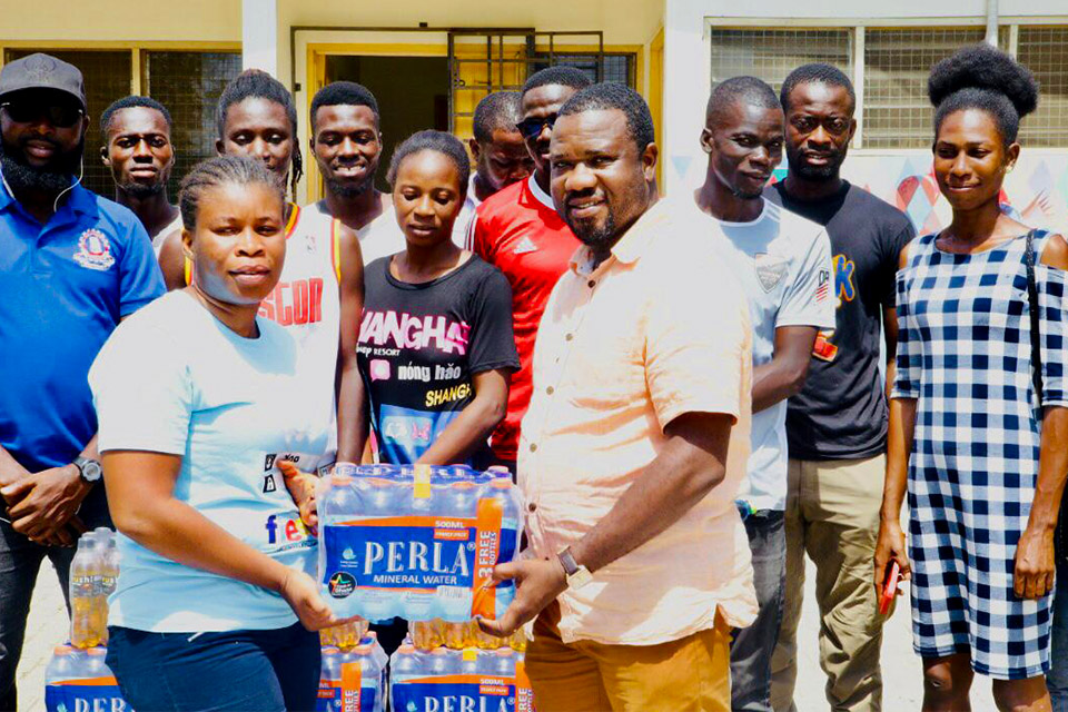 Dr. Evans Asante (right) presenting the items to the goalball team