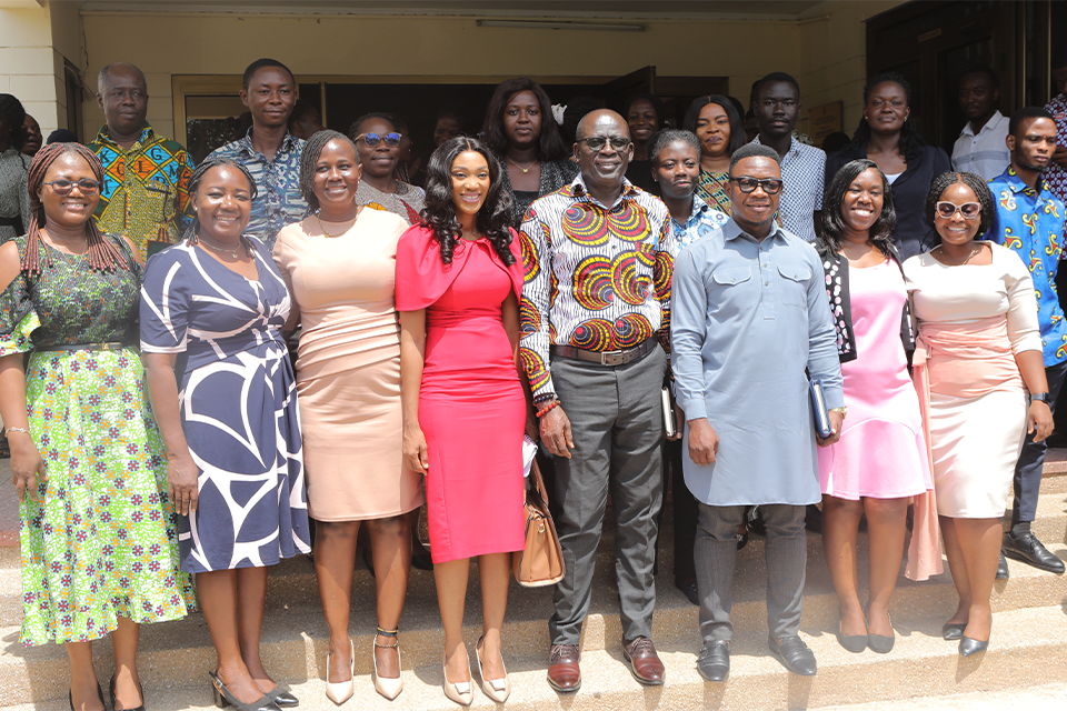 Faculty members pose for a group picture with the main speaker of the seminar