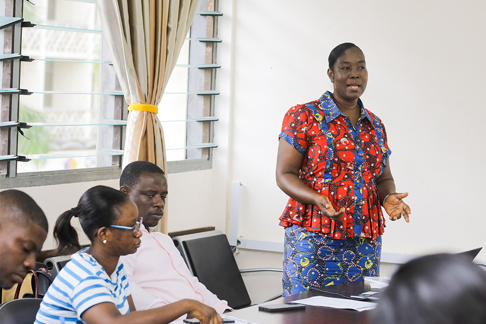 Mrs. Ekua Abedi-Boafo (standing), explaining the responsibilities of a secretary and how to write minutes and reports to participants