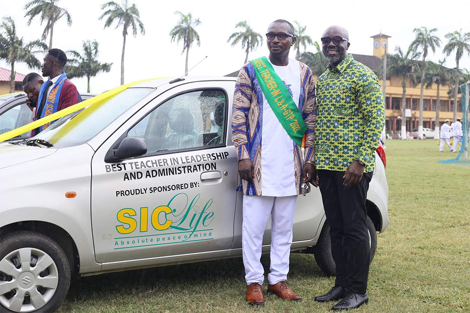 Mr. Abraham Fletcher poses beside the brand-new Suzuki Alto gifted to him by SIC Life Insurance