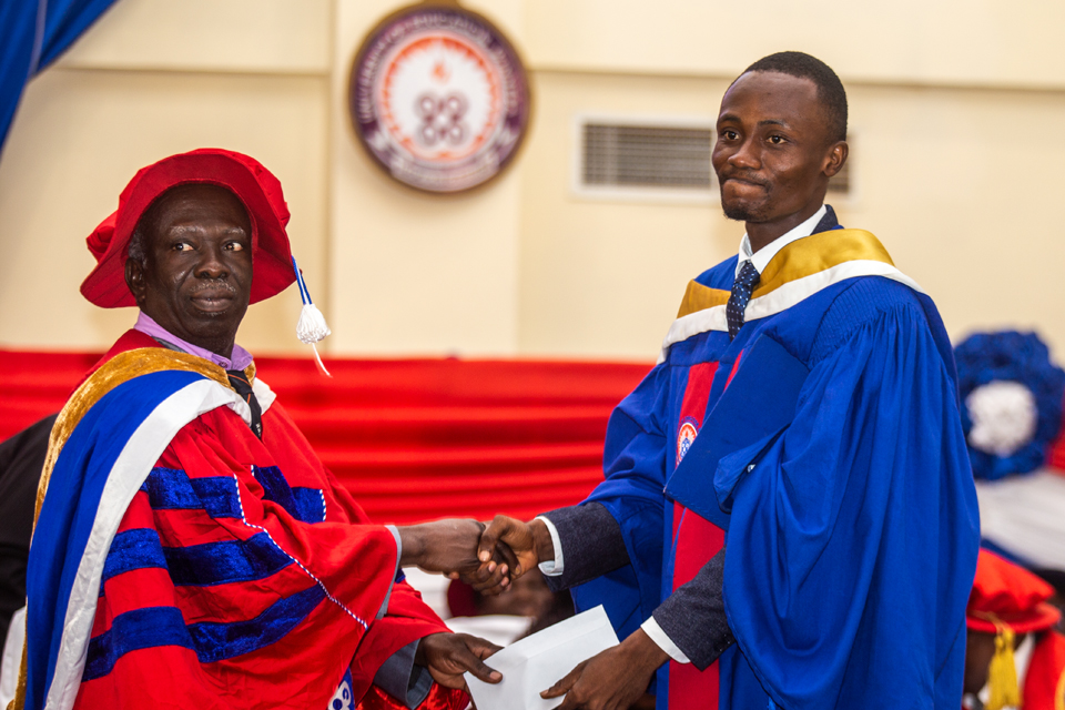 The valedictorian receiving his cash prize from the Dean of Science Education, Prof. Victus Samlafo 