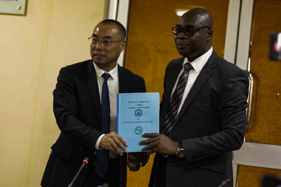 Prof. Stephen Jobson Mitchual (right) and Prof. Jimin Wang displaying the signed document