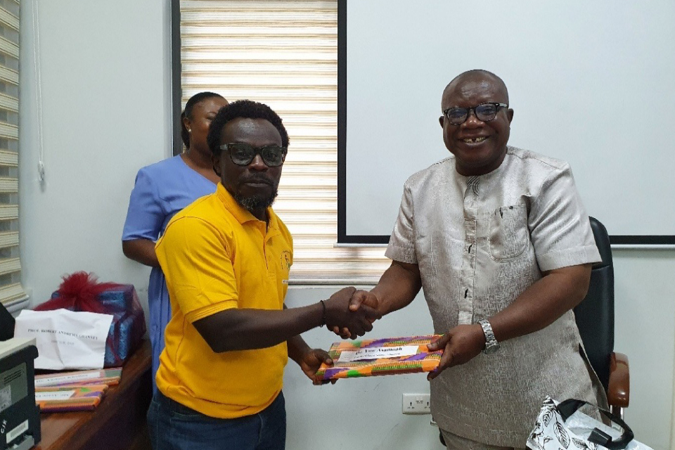 Prof. Ghanney presenting a token of appreciation to Dr. Yaw Asamoah, FQAO for Faculty of Social Sciences Education.