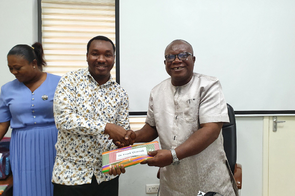 Prof. Ghanney presenting a token of appreciation to Dr. Frank Quansah, FQAO for Faculty of Applied Behaviourial Sciences in Education