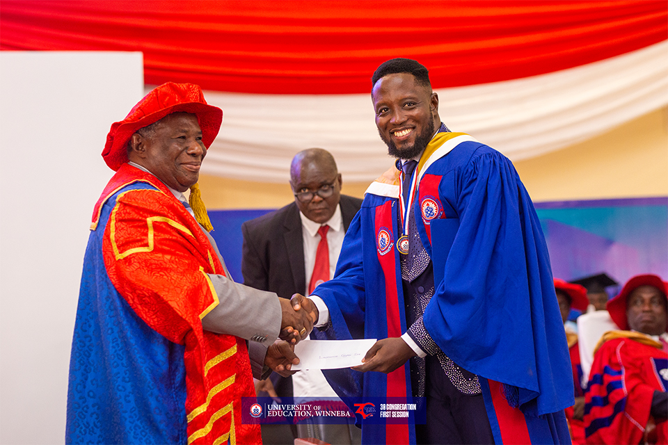 The Chancellor of UEW (right) presenting a cash prize to the valedictorian 