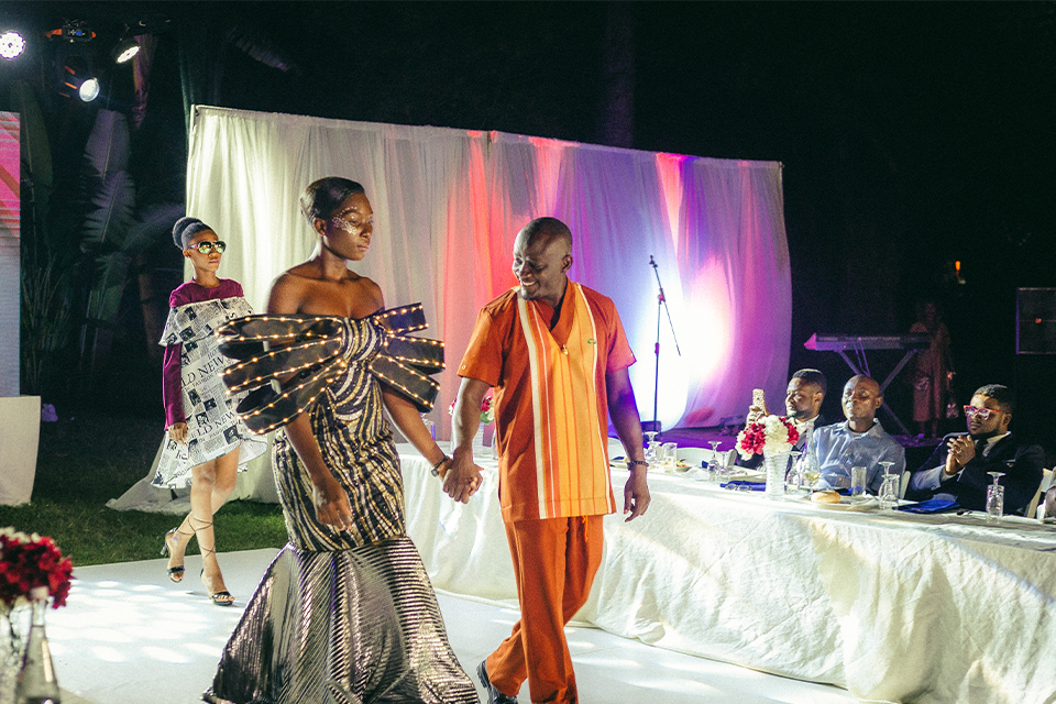 Raymond (right) rocks his collection, strutting with a fashionista 
