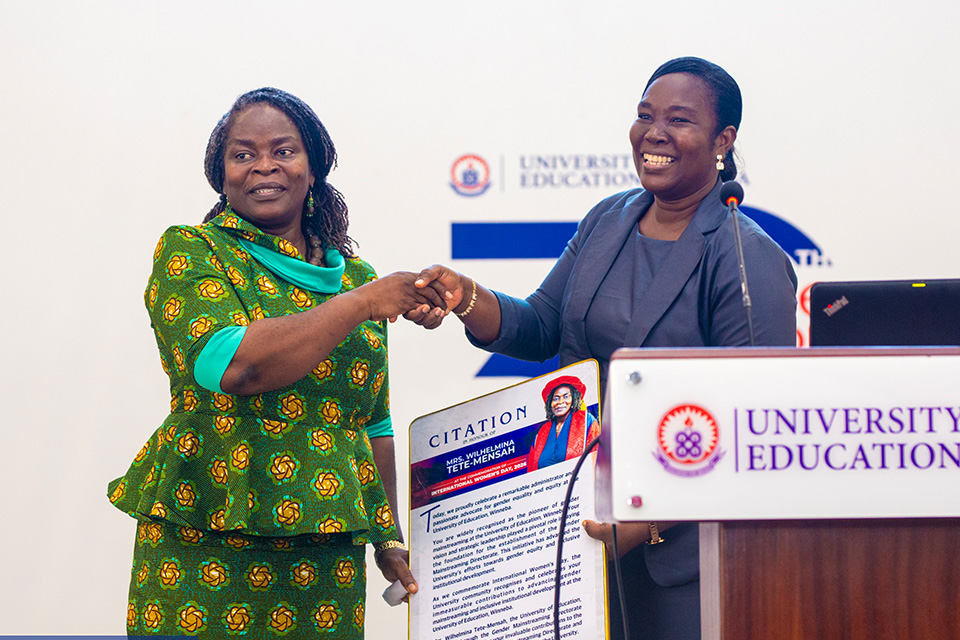 Mrs. Wilhelmina Tete-Mensah (left) receives a citation from Mrs. Ekua Abedi-Boafo