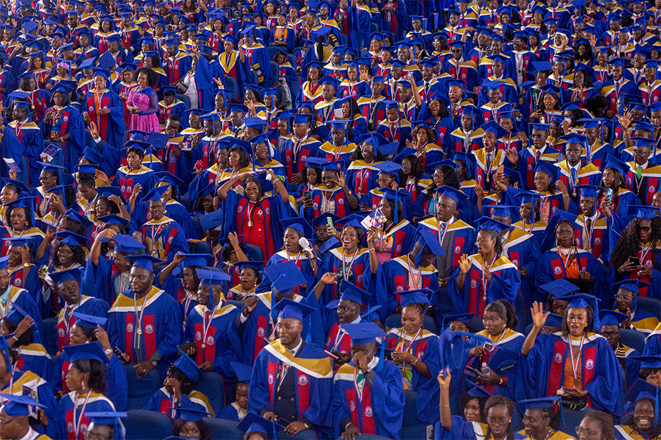 Graduating students cheered  as they moved their tassels from right to left