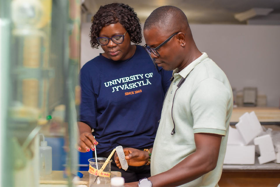 Dr. Nelly Sakyi-Hagan (left) conducting research in the laboratory