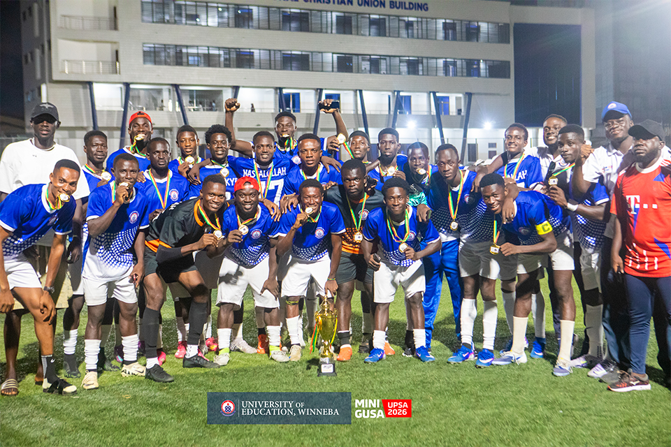 The men's football team proudly displays their gold medals in a group photograph 